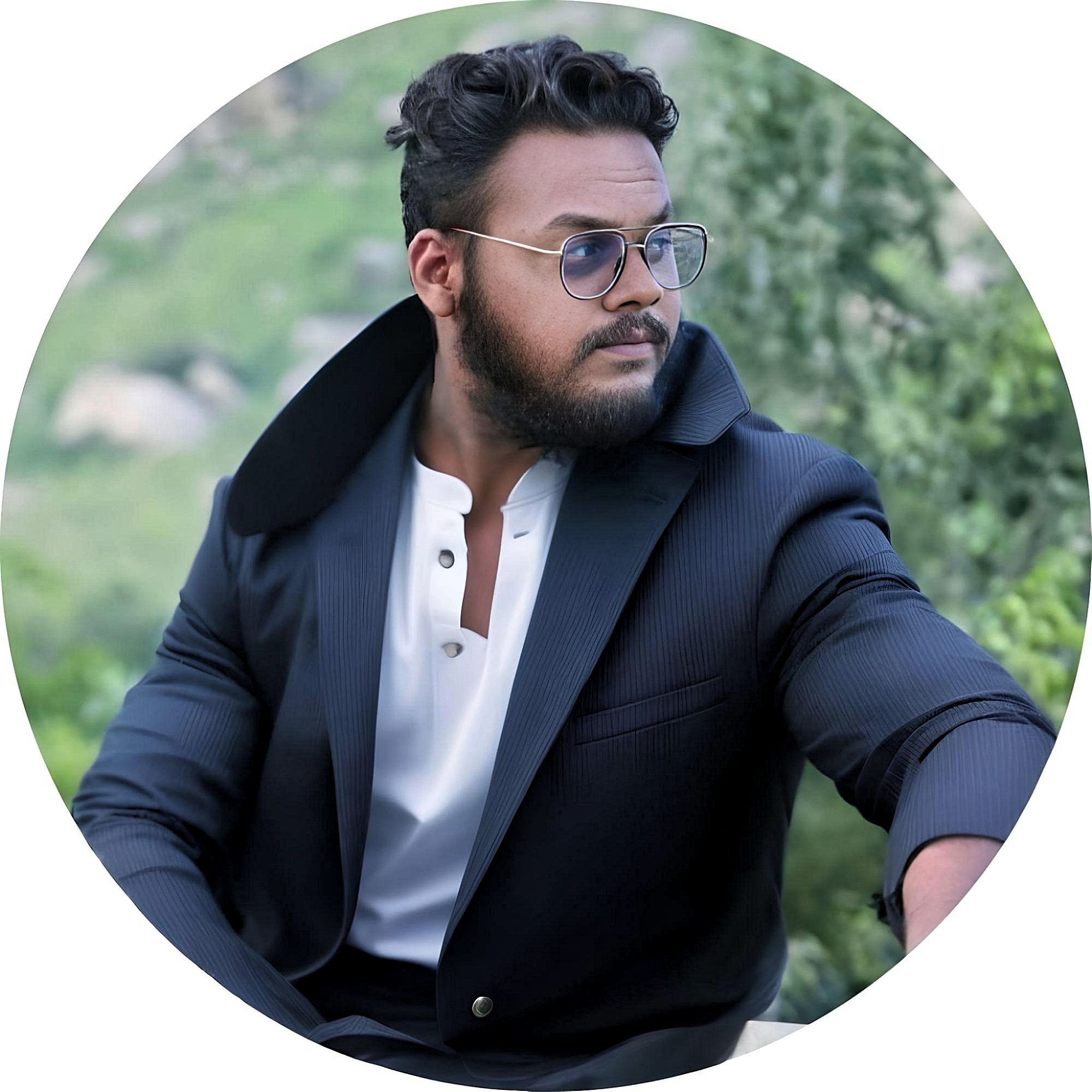 Marwan wearing a dark suit and sunglasses outdoors